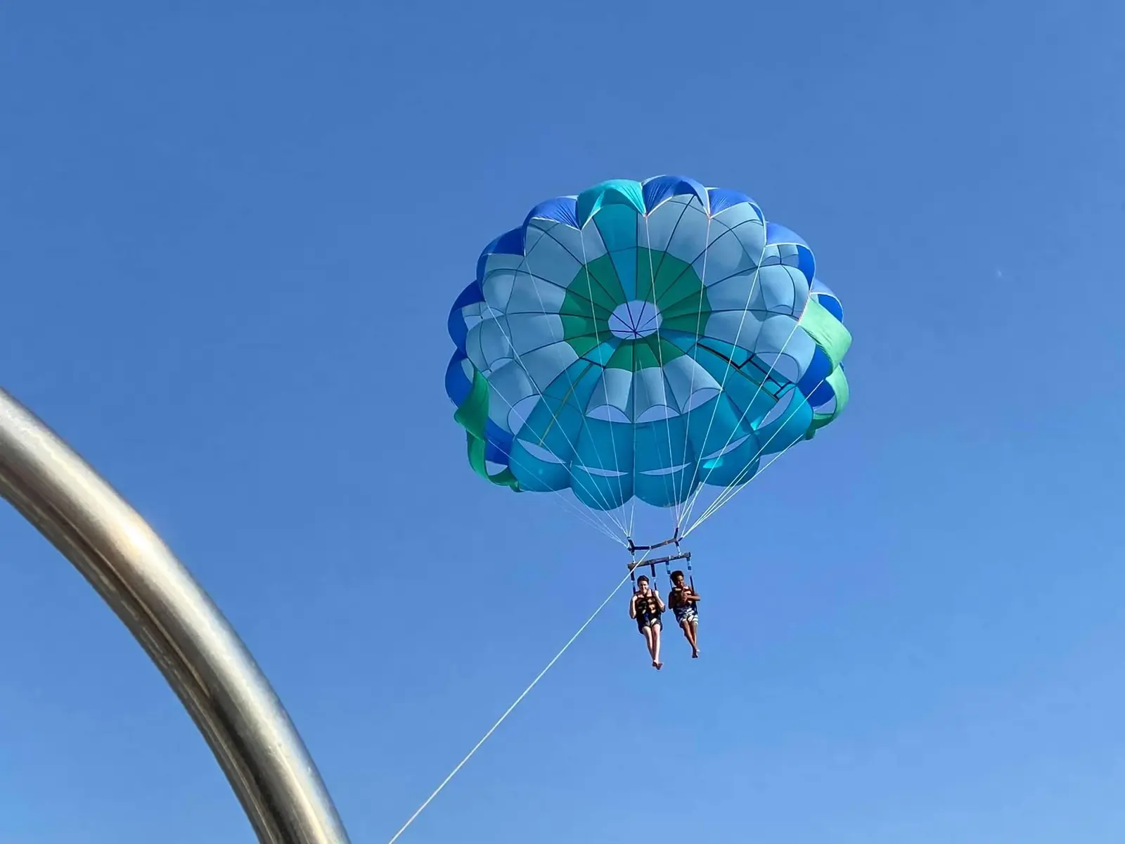 Parasailer soaring above the Arabian Gulf near Half Moon Bay