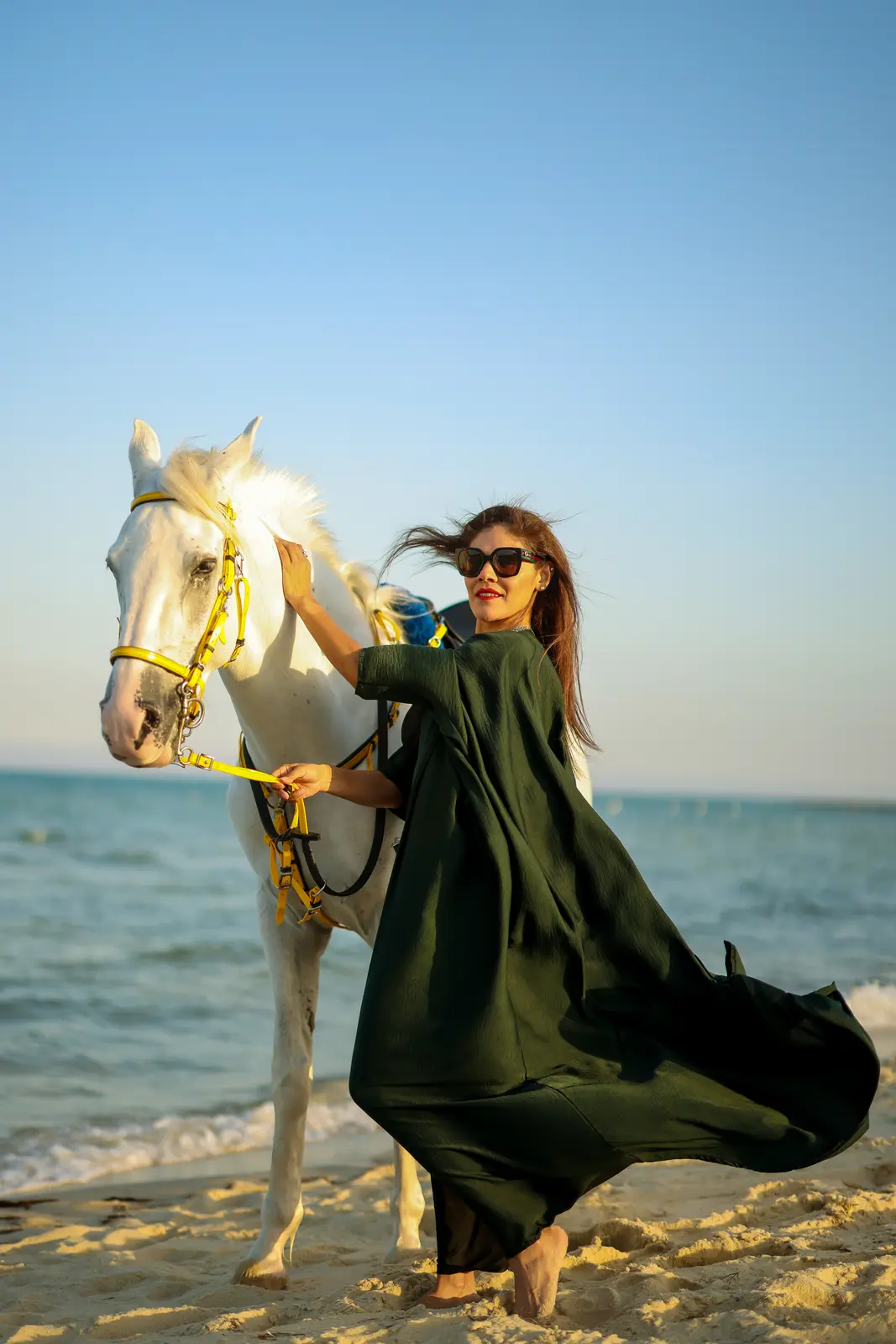 Rider enjoying a guided beach horse ride along the Half Moon Bay shoreline