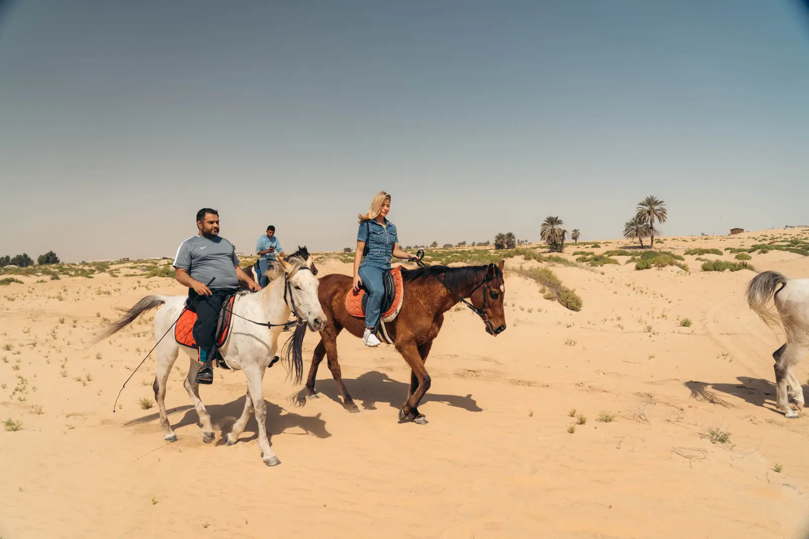 Group of beginner riders guided through the desert near Dammam