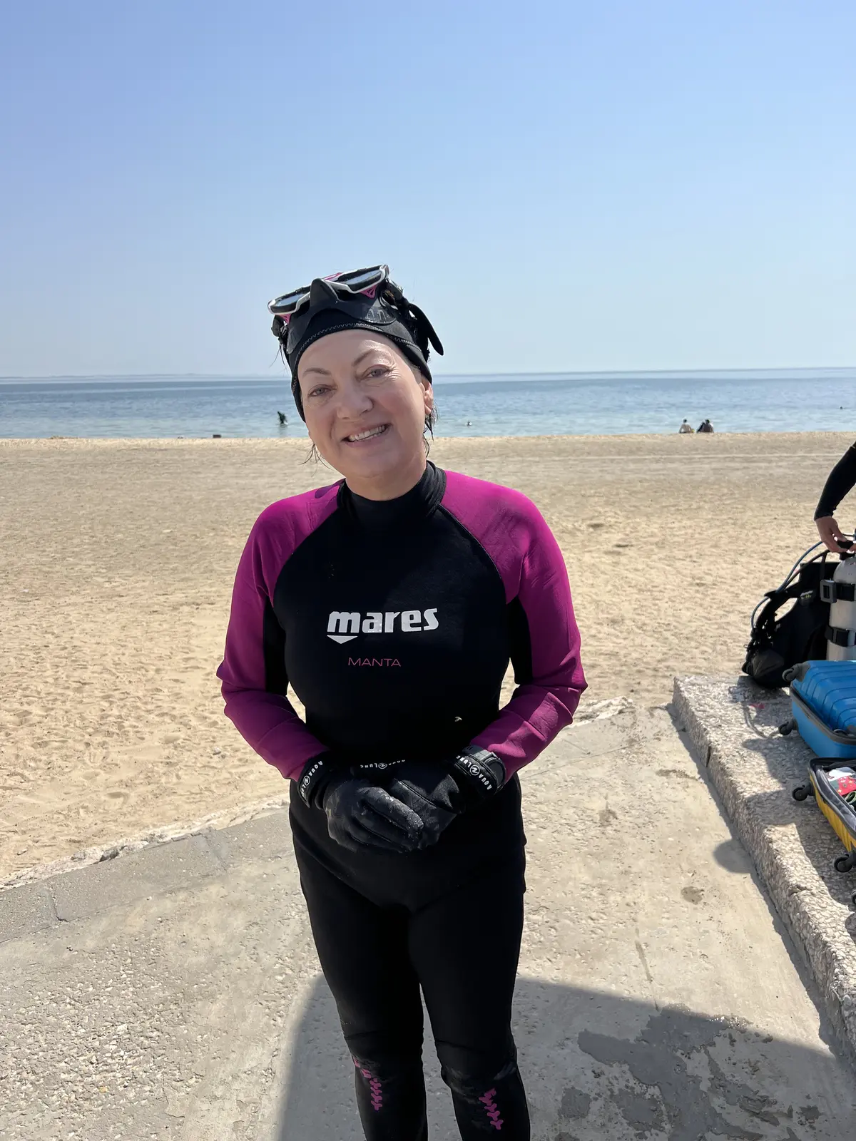 Smiling first-time diver ready for a beginner scuba session at Half Moon Beach